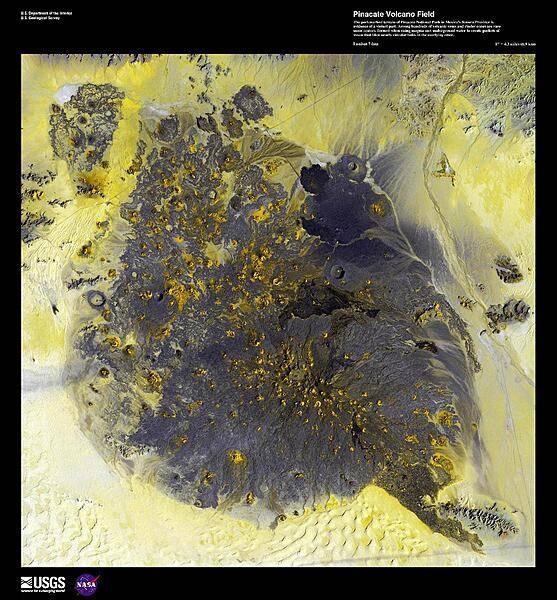 The pockmarked terrain of Pinacate National Park in Sonora province, shown in this enhanced satellite image, provides evidence of a violent geologic past. Among hundreds of volcanic vents and cinder cones are rare maar craters, formed when rising magma met underground water to create pockets of steam that blew nearly circular holes in the overlying crust. American astronauts used this area in 1965-70 to train for lunar excursions; surrounding the region are the vast sand dune fields of Gran Desierto de Altar. Image courtesy of USGS.