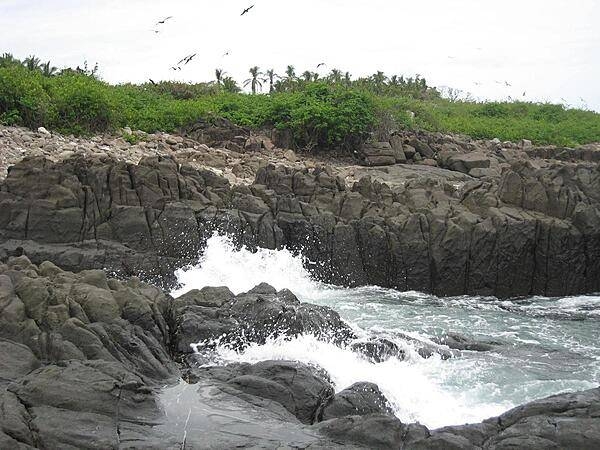 The rocky coast of Iguana Island on the Pacific coast of Panama. Sparsely inhabited by humans, this wildlife refuge teems with amazing bird and marine life.