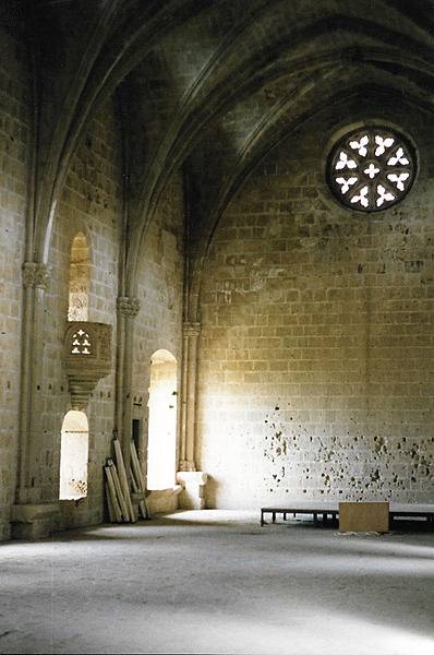 Although part of the Bellapais Abbey is in ruins, portions remain in use for religious services, concerts, and as a romantic setting for weddings. Shown here is the still very much intact refectory.