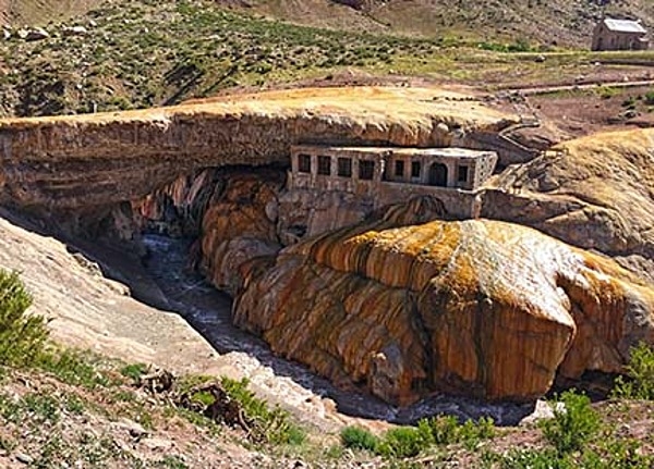 Puente del Inca, or "The Inca Bridge," is a natural bridge that spans the Cuevas River in Argentina's Mendoza province. Mineral deposits from hot springs have led to colorful shades of red and yellow on the face of the rocks.