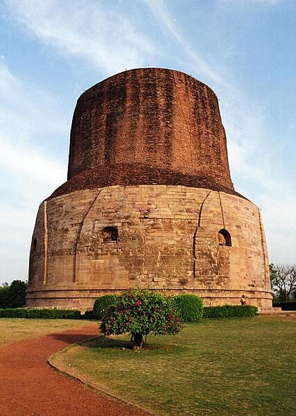 The Dhamek Stupa is located in Sarnath, India, where the Buddha preached his first sermon to his first five disciples. Emperor Ashoka of the Maurya Dynasty originally built the stupa -- a monument that contains sacred relics -- in 249 B.C. to help spread Buddhism; the structure was replaced around A.D. 500. The cylindrically shaped stupa is composed of red bricks and stones, and it stands 43.5 m (143 ft) high and 28 m (92 ft) wide, with carvings of flowers, birds, and humans on the walls.