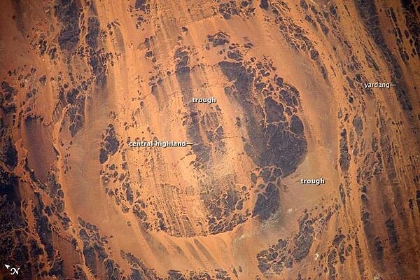 Aorounga Impact Crater, located in the Sahara Desert of north-central Chad, is one of the best-preserved meteor impact structures in the world. The crater is thought to be about 345-370 million years old, based on the age of the sedimentary rocks deformed by the impact. Radar data suggests that two other impact structures nearby are buried by sand deposits. Image courtesy of NASA.