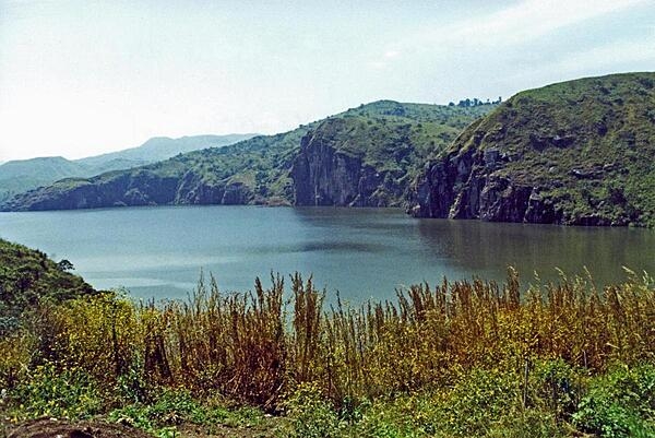 Lake Nyos is a crater lake on the flank of an inactive volcano in Cameroon. Magma beneath the lake leaks carbon dioxide into the waters. In 1986, the lake emitted a large cloud of carbon dioxide that suffocated nearly 1,800 people and some 3,500 livestock in nearby villages.