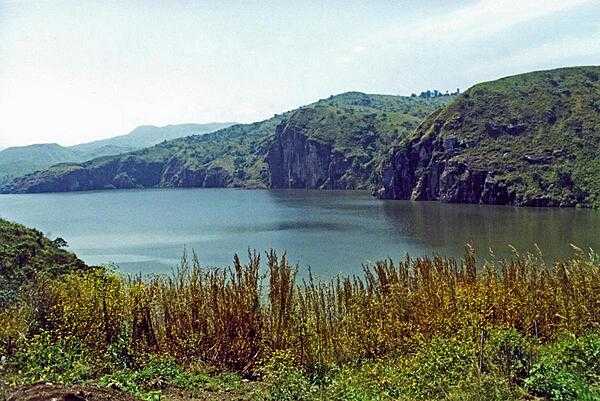 Lake Nyos is a crater lake on the flank of an inactive volcano in Cameroon. Magma beneath the lake leaks carbon dioxide into the waters. In 1986, the lake emitted a large cloud of carbon dioxide that suffocated nearly 1,800 people and some 3,500 livestock in nearby villages.