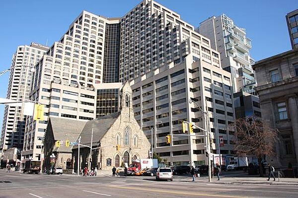 The historic Church of the Redeemer on the northeast corner of Bloor St. and Avenue Rd. in Toronto, Canada, was completed in 1879. It is dwarfed by the massive Four Seasons Renaissance Centre.