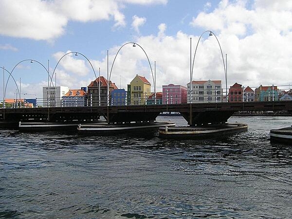 Spanning St. Anna Bay, the Queen Emma floating bridge at Willemstad, Curaçao, is the oldest permanent wooden pontoon bridge in the world. Known as the “Swinging Old Lady,” the now-pedestrian-only bridge connects Willemstad's two halves, Punda and Otrobanda, and was named after Emma of Waldeck and Pyrmont, who was queen consort of the Netherlands during its construction in 1888.