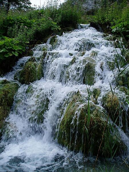 Close up of waterfalls in Plitvice Lakes National Park. The park is the largest and most popular of the eight national parks in Croatia and consists of 16 lakes that are linked but separated by natural dams.