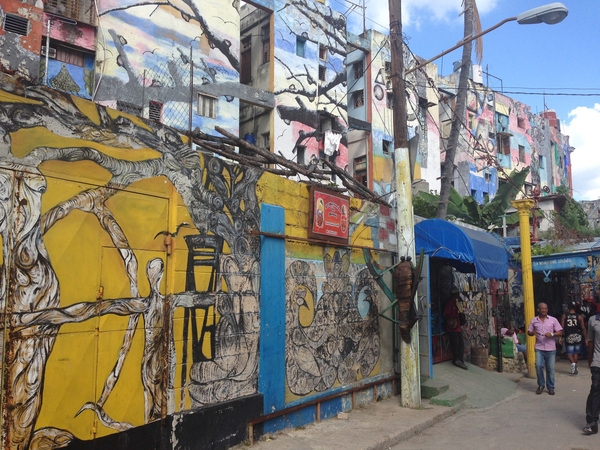 Street side and apartment wall murals help brighten a run down section of Havana, Cuba.