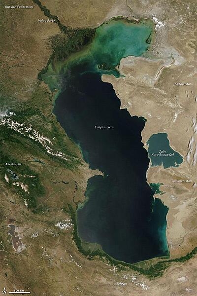 The Caspian Sea is the world's largest inland water body, covering roughly 371,000 sq km (143,200 sq mi) and bordering five countries. The color of the Caspian Sea darkens from north to south, due to changes in depth and perhaps sediment and other runoff. The northern part of the lake is just 5 to 6 m (16 to 20 ft) deep. The southern end, however, plunges more than 1,000 m (3,300 ft). Multiple rivers empty into the Caspian Sea, the Volga being the largest. Image courtesy of NASA.