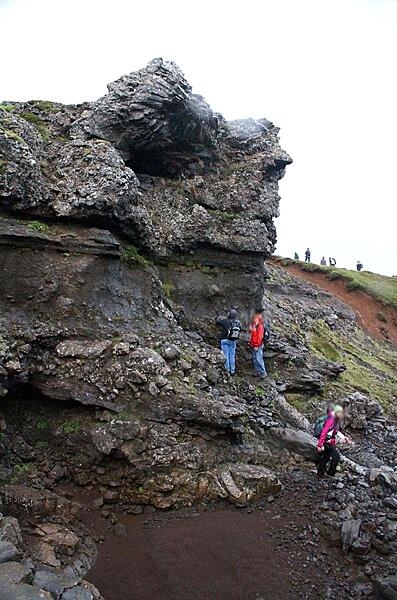 A dike (volcanic feeder tube) merging into layered strata in Iceland's Thingvellir National Park.