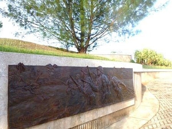 Bronze relief on a memorial in Guam's War in the Pacific National Historical Park. Established in 1978, the park is composed of various sites on the western shore of the island. During World War II, Japanese forces captured Guam in 1941, and the Americans liberated it in 1944. The park includes former battlefields, gun emplacements, trenches, caves, and historic structures. Photo courtesy of the US National Park Service.