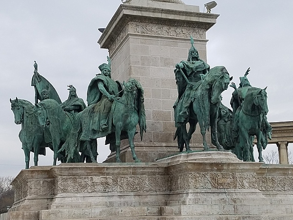 Statues of seven mounted figures at the base of the Millennium Monument column in Budapest, Hungary, represent the Magyar chieftains who led the Hungarian people to settle in the Pannonian Plain of central Europe.