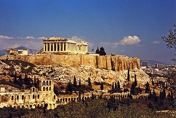 The Parthenon crowns the Acropolis in Athens, Greece. The Acropolis is a citadel on a flat, high, rocky outcrop 150 m (490 ft) above sea level and is the highest point in Athens.