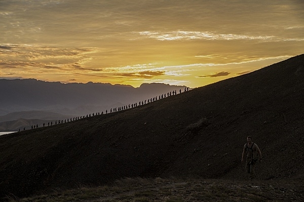 As part of a multinational training exercise, US Marines and US Sailors, Australian soldiers, and British soldiers hike a hill along the Kokoda Track in Papua New Guinea in 2015. The exercise was designed to provide assistance to Papua New Guinea through infrastructure rehabilitation and basic military training. Photo courtesy of the US Marine Corps/ Cpl. William Hester.