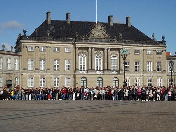 One of four identical rococo buildings making up the Amalienborg Palace in Copenhagen, Denmark. The crowds gather to watch the changing-of-the-guard ceremony.