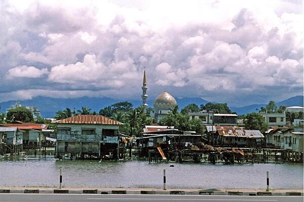 A view of the water village of Kampong Ayer in Brunei; the Sultan Omar Ali Saifuddin Mosque appears in the background.