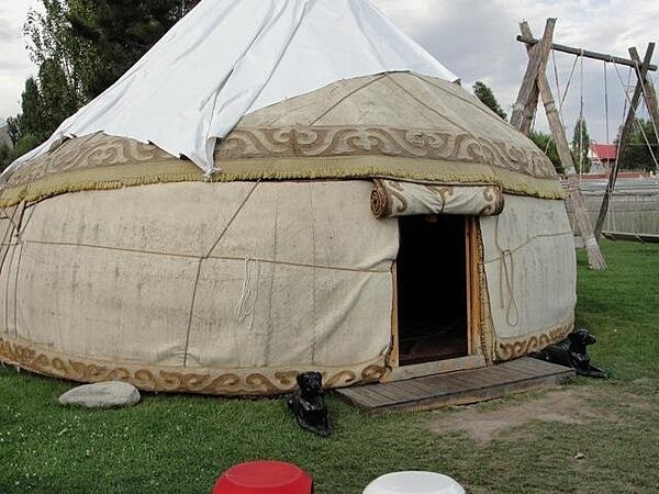 A typical Kyrgyz yurt, a portable, bent-wood framed shelter covered by layers of fabric, typically felt.