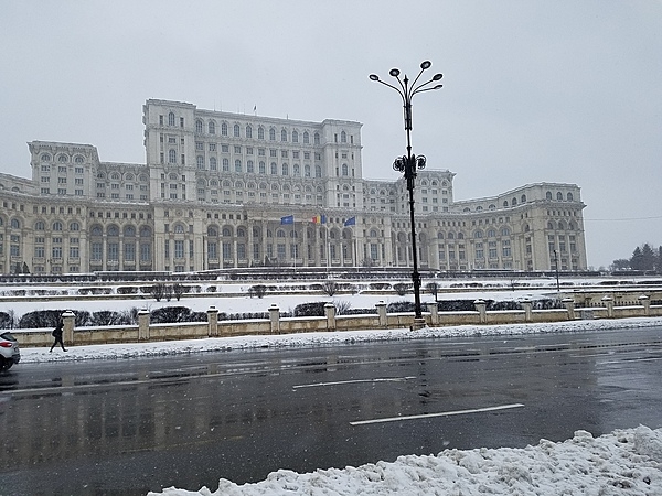 Exterior of the Palace of the People in Bucharest. The building was constructed between 1984 and 1997 on orders of Nicolae Ceausescu, the dictator of communist Romania. The structure is the world's third-largest building by floor area (after the Pentagon in Washington, DC and the Long'ao Building in China) with 1,100 rooms; it consists of 12 floors above ground and 8 floors below. The edifice hosts the two houses of Romania's Parliament (the Senate and the Chamber of Deputies), three museums, and an international conference center. Nonetheless, about two-thirds of the building remains unoccupied.