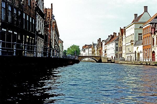 A bridge over a quiet canal in Bruges (or Brugge), Belgium.