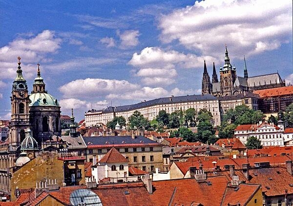 The Hradcany (Castle District) in Prague, Czechia. Its two most prominent features are St. Vitus Cathedral (upper right) and Prague Castle (the long white building, which is one of the largest castles in the world).