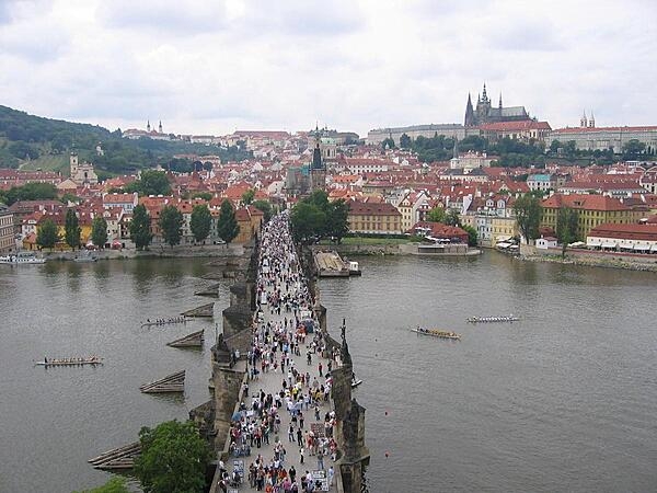 The bustling, pedestrian-friendly Charles Bridge in Prague, Czechia, as viewed from the tower on the Stare Mesto (Old Town) side of the structure. The bridge is 516 m (1,693 ft) long and almost 10 m (33 ft) wide, and it rests on 16 arches shielded by ice guards. Thirty statues of saints decorate the bridge avenue; most were erected between 1683 and 1714, but then replaced with replicas beginning in 1965. The originals are currently housed in the National Museum.