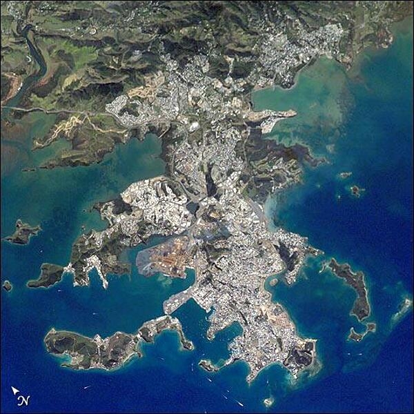 This image shows details of New Caledonia&apos;s main city, Noumea, which is built on a peninsula that juts into the lagoon on the southwest side of the island. The reefs here face problems from pollution and overfishing. The tourism industry is very important to the economy of Noumea, with extensive hotel development in the city and along the southeast coast of New Caledonia Island. The picture shows how urban development extends to the steep slopes of the coastal hills. Image courtesy of NASA.