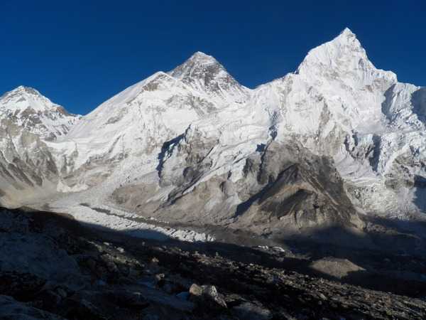 Mt. Everest (in the middle), behind the two peaks of Mt. Nuptse as seen from Kala Pathar in  Sagarmatha National Park. The glacier in front of the two peaks of Mt. Nuptse is the Khumbu Glacier. The mountain to the far left is Mt. Changtse located in Tibet. In front of Mt. Changtse is the Khumbu Icefall, which those who want to summit Everest must climb.