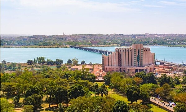 Niamey, the capital and largest city of Niger, lies on the Niger River, primarily situated on the east bank. The Kennedy Bridge, built in 1970, is the main crossing for the Niger River and is named for US President John F. Kennedy. Its construction enabled Niamey to expand onto the right (west) bank of the river. Located in a semi-arid part of the continent, Niamey is remarkably hot throughout the year and is one of the hottest major cities on the planet.