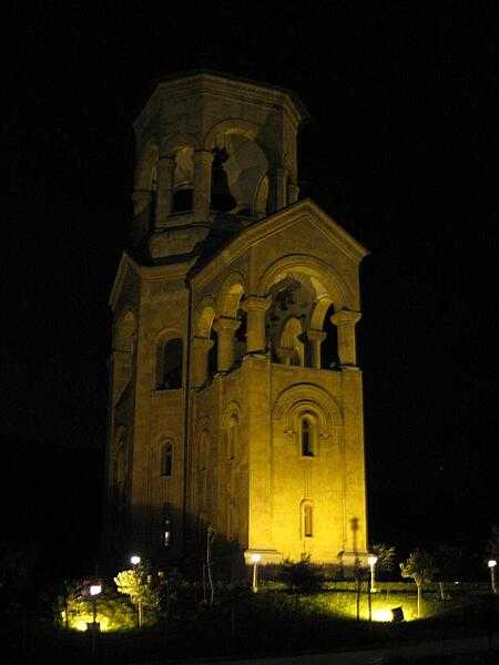 A nighttime view of the free-standing bell tower and chapel of the Sameba (Holy Trinity) Cathedral, a part of the Sameba complex on Elia Hill overlooking Tbilisi, Georgia.