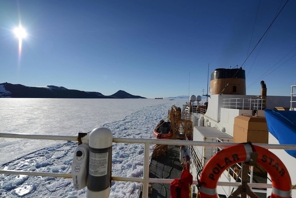 US Coast Guard Cutter Polar Star, a heavy icebreaker homeported in Seattle, Washington, rests in the ice as the motor vessel Ocean Giant departs from the National Science Foundation's McMurdo Station on 1 February 2017. One of the primary responsibilities of the Polar Star's crew is to provide an escort for the Ocean Giant through the frozen Ross Sea off of Antarctica. Photo courtesy of the US Coast Guard/ Chief Petty Officer David Mosley.