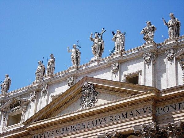 A statue of Christ and some of his apostles on the façade of St. Peter's Basilica in Vatican City.