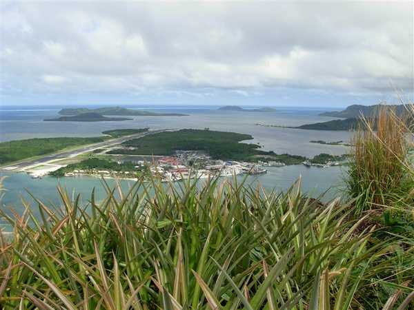 A view eastward from Pailapap on the island of Pohnpei showing Pohnpei International Airport and harbor. Pohnpei International Airport (IATA code: PNI) is located on the small island Deketik and is connected to Kolonia via the Deketik causeway. Photo courtesy of NOAA / Lt. Cmdr. Matthew Wingate.