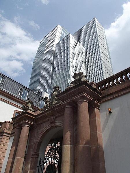 An 18th century archway of the Palais Thurn und Taxis and 21st century skyscrapers (Nextower) provide an interesting architectural juxtaposition in Frankfurt, Germany.