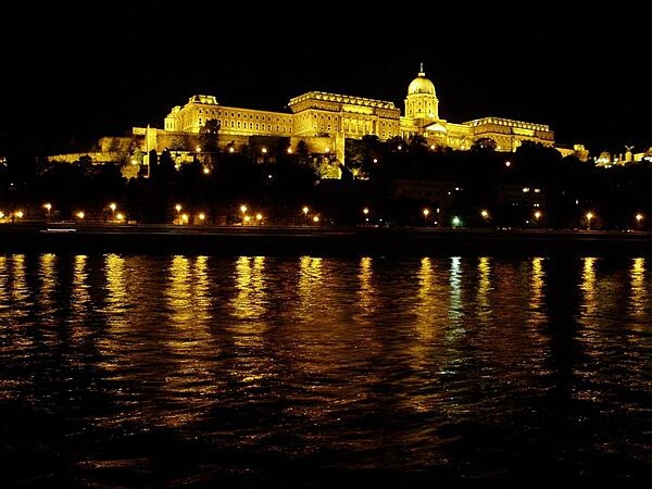 A night-time view of Buda's Royal Castle as seen from along the Danube in Pest in Hungary.