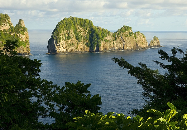 This view is a classic example of steep cliffs and erosion-resistant outliers formed by wave action on a volcanic land mass. Pola Island rises over 125 m (400 ft) straight out of the ocean off Tutuila in American Samoa. A short walk from Vatia village, Pola is an ideal nesting site for many species of seabirds. Photo courtesy of the US National Park Service.