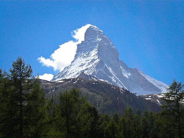 The Matterhorn is a pyramidal mountain on the border between Switzerland and Italy. Its summit is 4,478 m (14,692 ft) high, making it one of the highest, most famous, and deadliest peaks in the Alps. The steep faces, oriented to each compass point, cause regular avalanches; the snow that builds up around the base forms glaciers. Mountains around the world with similar profiles frequently earn &quot;Matterhorn&quot; as a nickname because of the mountain&apos;s iconic shape.