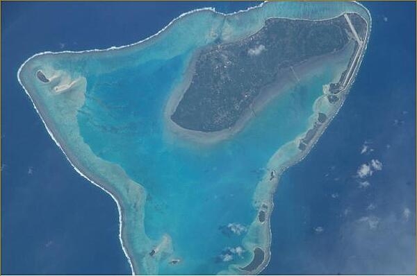 A close up view of Aitutaki in the Cook Islands. The island's airport may be seen on the northern point (upper right). Image courtesy of NASA.