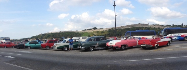 At a Cuban car park. After Castro gained control of the island nation in 1959, a US trade embargo banned the export of vehicles and parts to Cuba. Today, Cubans are once again allowed to buy and sell cars, and some European  automakers offer new cars for sale in Havana and other Cuban cities. Unfortunately, most Cubans are unable to afford them, so they continue to drive classic cars. Some 60,000 pre-revolution cars remain on the road.