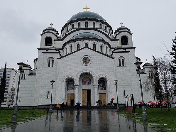 The Church of Saint Sava in Belgrade is the largest Serbian Orthodox church and the largest Orthodox place of worship in the Balkans.  Dedicated to Saint Sava, the founder of the Serbian Orthodox Church, the church is located near the presumed location of his grave. Construction on the structure began in 1935 and was interrupted many times because of various conflicts; it was finally consecrated in 2004. The Church of Saint Sava has more than 49 bells in its bell towers, over 18 gold-plated crosses on its domes and a central dome that weighs 3628 metric tons (4,000 tons).