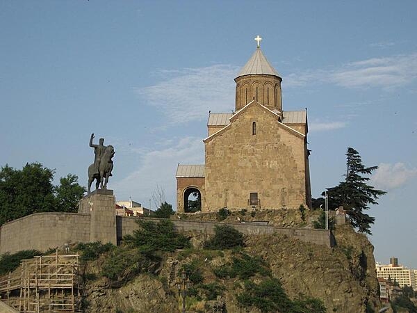 The Metekhi Church of the Assumption in Tbilisi, Georgia, is located on a cliff overlooking the Mtkvari River and dates to the 13th century. The equestrian statue of King Vakhtang I Gorgaslan was erected in front of the church in 1961.