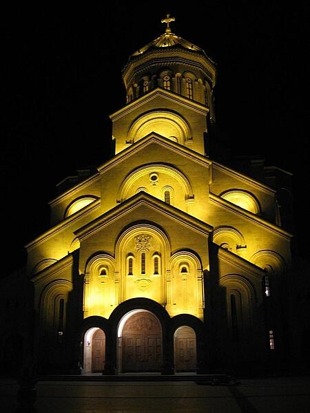 A nighttime view of the Sameba (Holy Trinity) Cathedral in Tbilisi, Georgia.