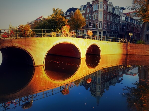 The Netherlands is located at the mouths of three major European rivers: the Rhine, the Meuse, and the Scheldt. About a quarter of the country lies below sea level and only about half of the land exceeds one meter (3.2 ft) above sea level. This is also reflected in the country name which literally means “the lowlands.”  When building Amsterdam, the capital, the development of canals drained much of the swampland allowing for the development of a new ‘port city’ built at the end of the 16th and beginning of the 17th centuries. This Canal Ring of Amsterdam inside the Singelgracht or fortified boundaries became a UNESCO site in 2010. With 165 canals, Amsterdam is the city with the most canals in the world.