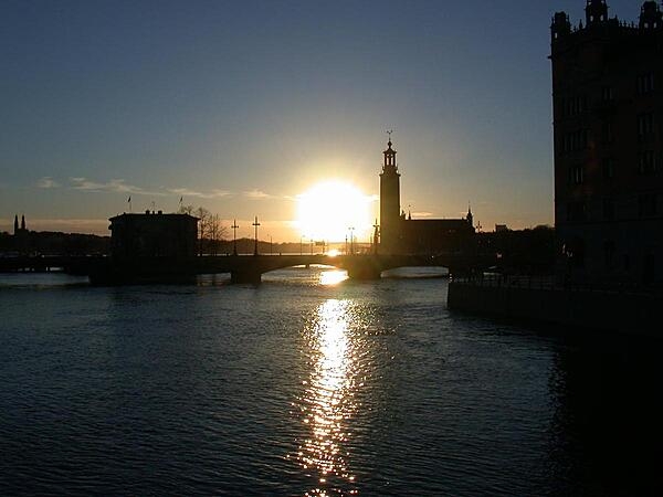 A Stockholm sunset outlines the distinctive City Hall (Stadshuset) on Lake Malaren.