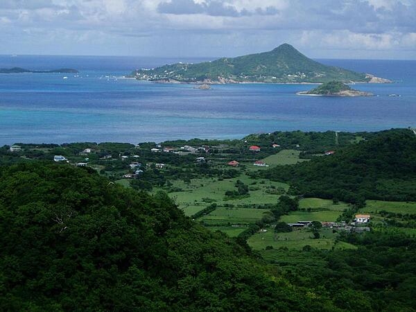 Photo taken from the island of Carriacau, which is part of Grenada. The island visible on the horizon is Petit Martinique, also part of Grenadan territory.