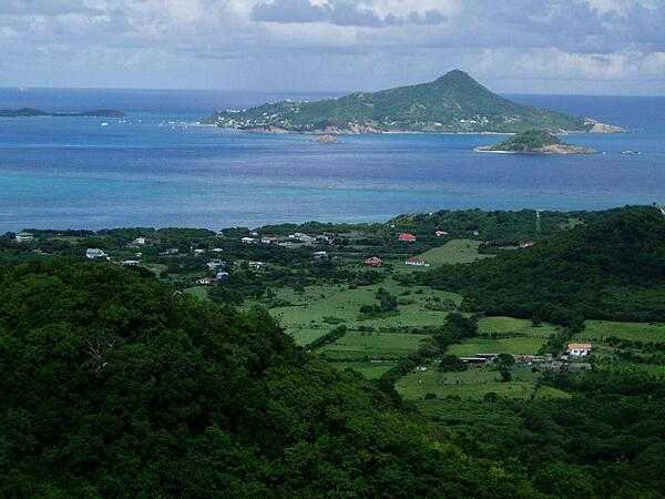 Photo taken from the island of Carriacau, which is part of Grenada. The island visible on the horizon is Petit Martinique, also part of Grenadan territory.