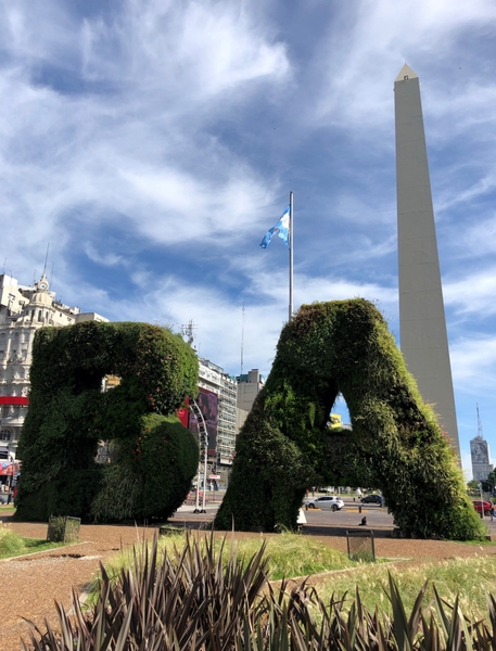 The Avenida 9 de Julio, shown here with a view of the Obelisk (El Obelisco) and the "BA" topiary, is the main thoroughfare of downtown Buenos Aires, Argentina, and is considered the widest avenue in the world. The Plaza de la Republica is a favorite gathering spot for local celebrations.