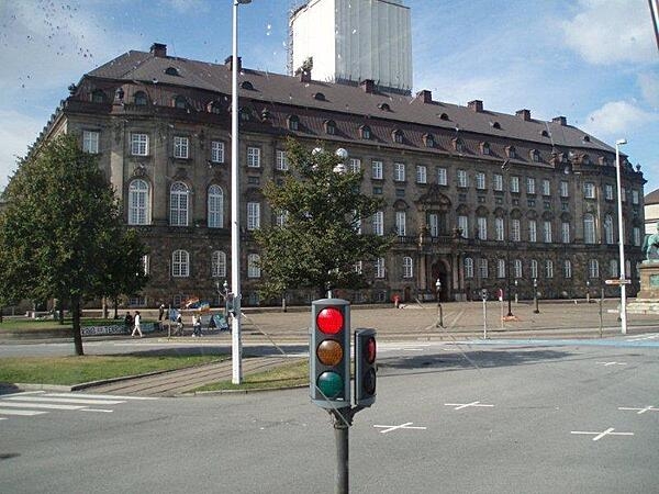 Side view of Christiansborg Palace on the island of Slotsholmen in central Copenhagen, Denmark. The structure serves as the seat of the Folketinget (the Danish parliament), the prime minister's office, and the Danish Supreme Court. It is the only building in the world where all three branches of government -- the executive, legislative, and judicial -- are housed in one building.