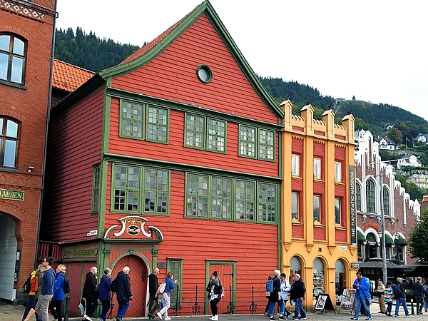 Brightly painted warehouses along the Hanseatic Wharf in Bryggen, the dock area of historic Bergen.  The yellow and orange building is the Hanseatic Museum. The Bryggen has been a UNESCO World Cultural Heritage site since 1979.