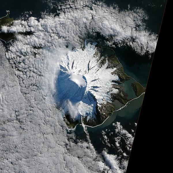 In October 2012, satellites picked up signals that suggested volcanic activity on remote Heard Island. These images, captured several months later, show proof of an eruption on Mawson Peak. By April 2013, Mawson's steep-walled summit crater had filled, and a trickle of lava had spilled down the volcano's southwestern flank. Image courtesy of NASA.