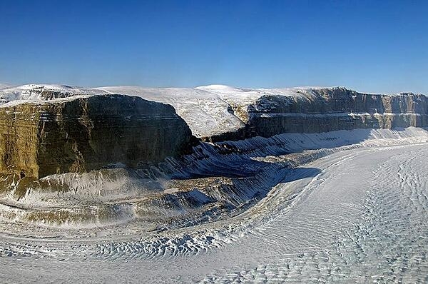 The Steensby Glacier in norothern Greenland flows around a sharp bend in a deep canyon. The glacier is located at 81 degrees north in Nyboe Land and flows into the St. Georges Fjord. Credit: NASA/Michael Studinger.